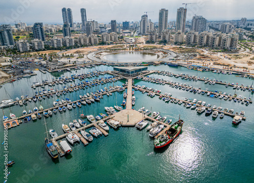 Ashdod city complete beautiful panoramic aerial view from the sea showing it modern marina symmetric open landscape and sky scrapers in the distance with overcast skies photo