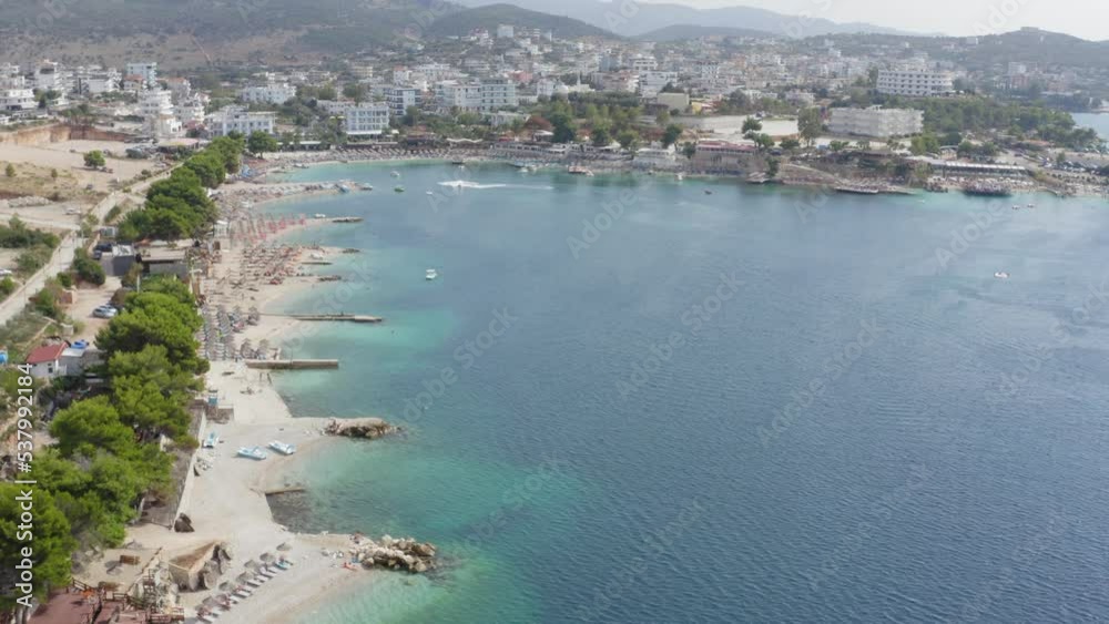 Drone flying over Ksamil Beaches and Restaurants on Mediterranean Sea in Albania and Greece Drone flying over Ksamil Beaches and Restaurants on Mediterranean Sea in Albania and Greece