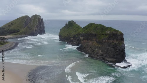 Drone circling Hole in the Wall with ocean water crashing through Hole, Transkei South Africa photo