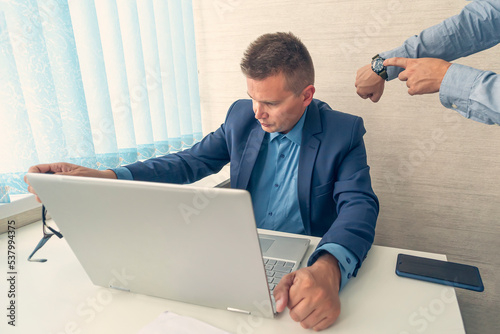Keep track of time. man point at clock. Work time or working hours. Time management. Office life. Time for work. being late at work. boss scolds the employee for being late or overdue work. deadline