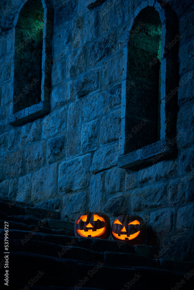 Halloween pumpkins jack p lantern in the yard of an old castle at night in the bright moonlight - obrazy, fototapety, plakaty 
