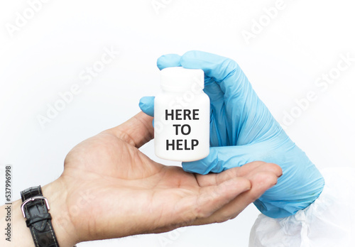 HERE TO HELP the text on the label of the jar, the doctor hands the patient a white jar of the medicine. Medical concept