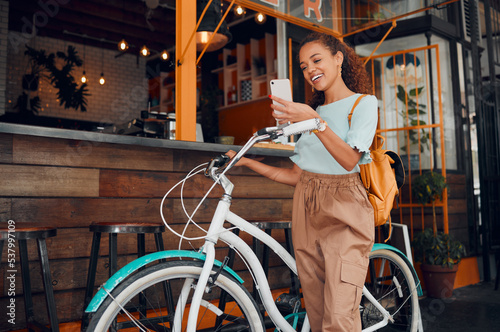 Photography Woman, happy and bike with phone at cafe on travel in city with bag