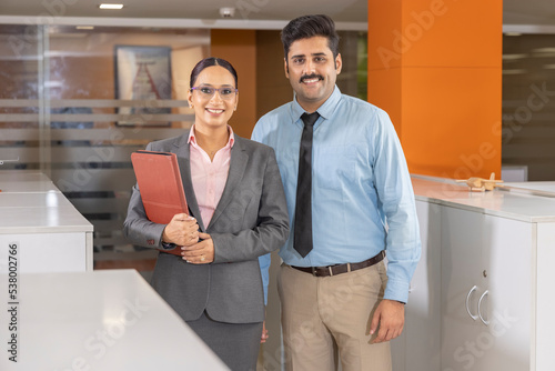 Photography Businesswoman discussing over document with colleagues in office