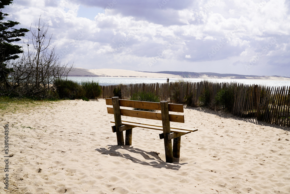wooden relax bench seat on sea coast atlantic ocean in Cap Ferret France with pyla dune du pilat view