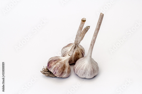 Three heads of garlic on a white background.