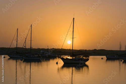 Aerial view of boats riding on sea during sunset photo