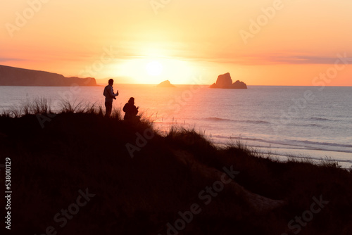 couple watching the sea at sunset