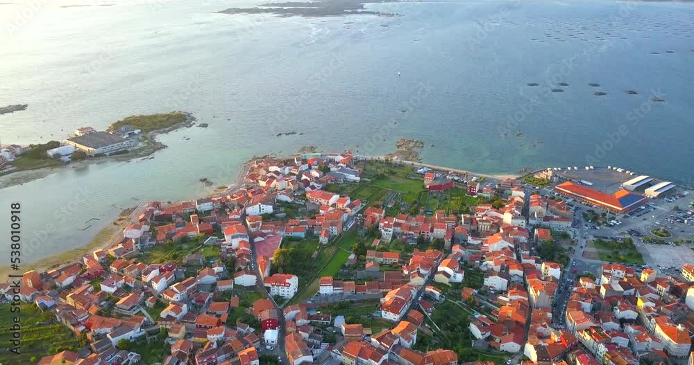 Aerial view over O Grove bay, Galicia, Spain at sunset. On the horizon a view of the ocean. Aerial view over O Grove bay, Galicia, Spain at sunset. On the horizon a view of the ocean.