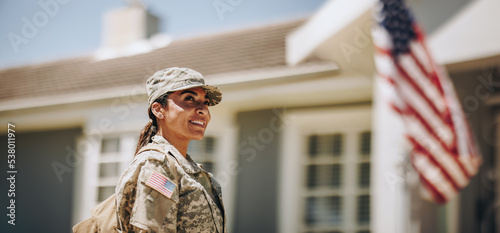 Happy female soldier returning home from the military photo