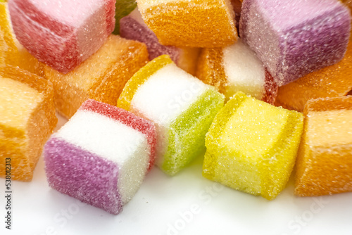 Colorful jelly candy mix white granulated sugar on white background