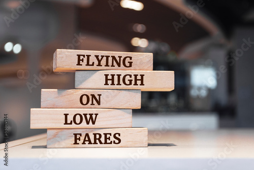 Wooden blocks with words 'Flying High on Low Fares'.