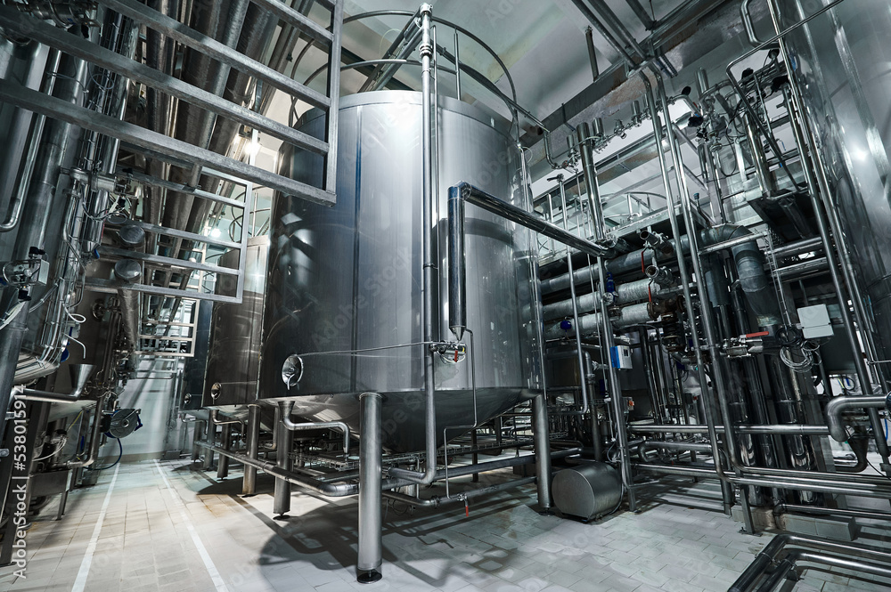 Stainless steel tanks, many pipes and valves, food production. Stainless steel tanks, many pipes and valves, food production.