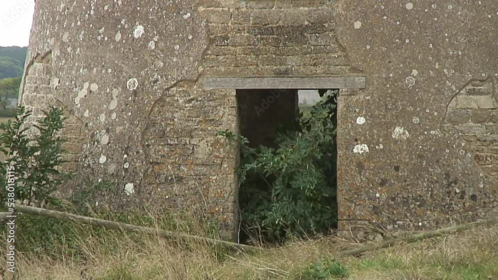 Close up of an 18th century derelict windmill located in a grass field in Ketton, a village in the English county of Rutland Close up of an 18th century derelict windmill located in a grass field in Ketton, a village in the English county of Rutland