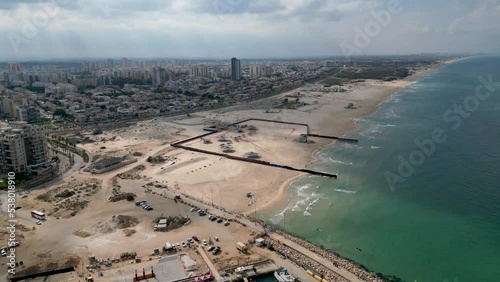 Aerial 4k scenic video of Ashdod beach front almost completely vacant during an overcast cloudy day