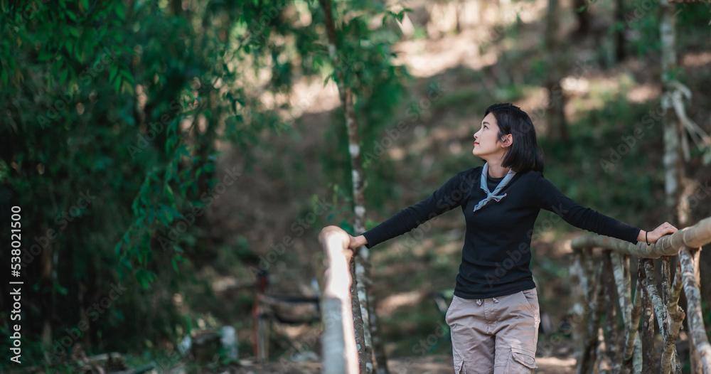 Protrait young woman looking beautiful nature while camping in forest Protrait young woman looking beautiful nature while camping in forest