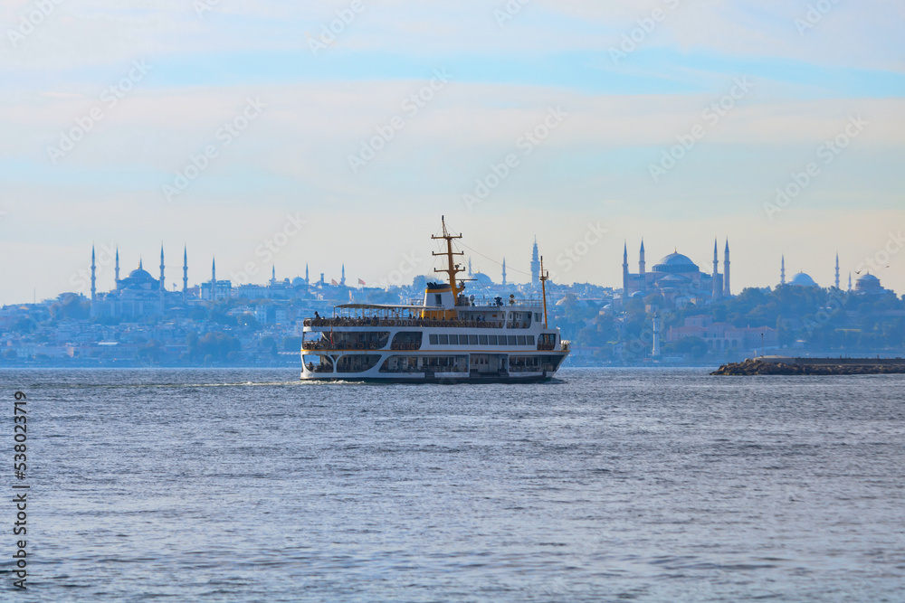 Ferries of Istanbul. A ferry from Kadikoy and Istanbul skyline on background