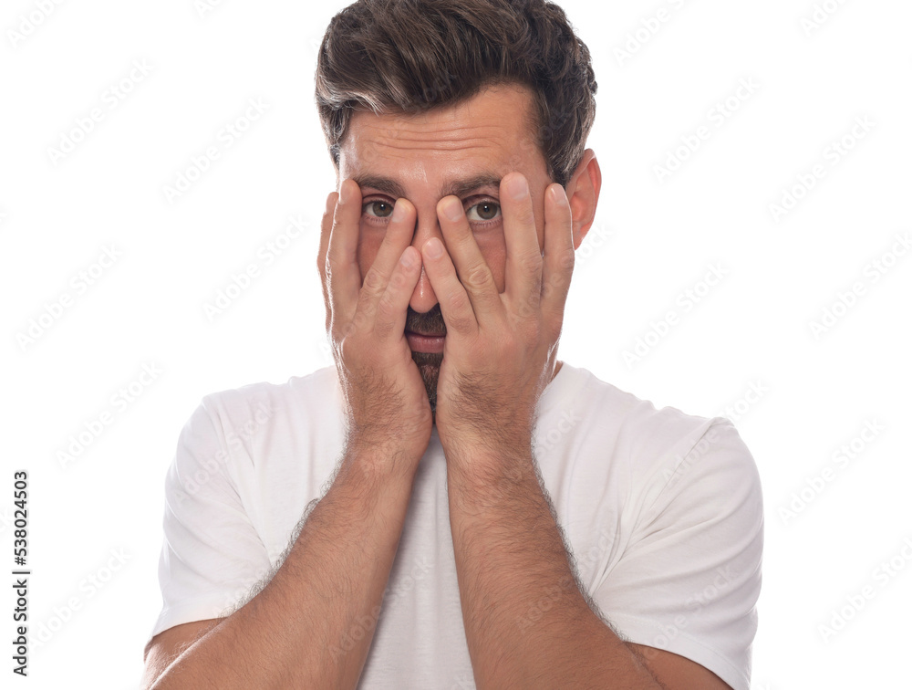 Embarrassed man covering face with hands on white background Embarrassed man covering face with hands on white background