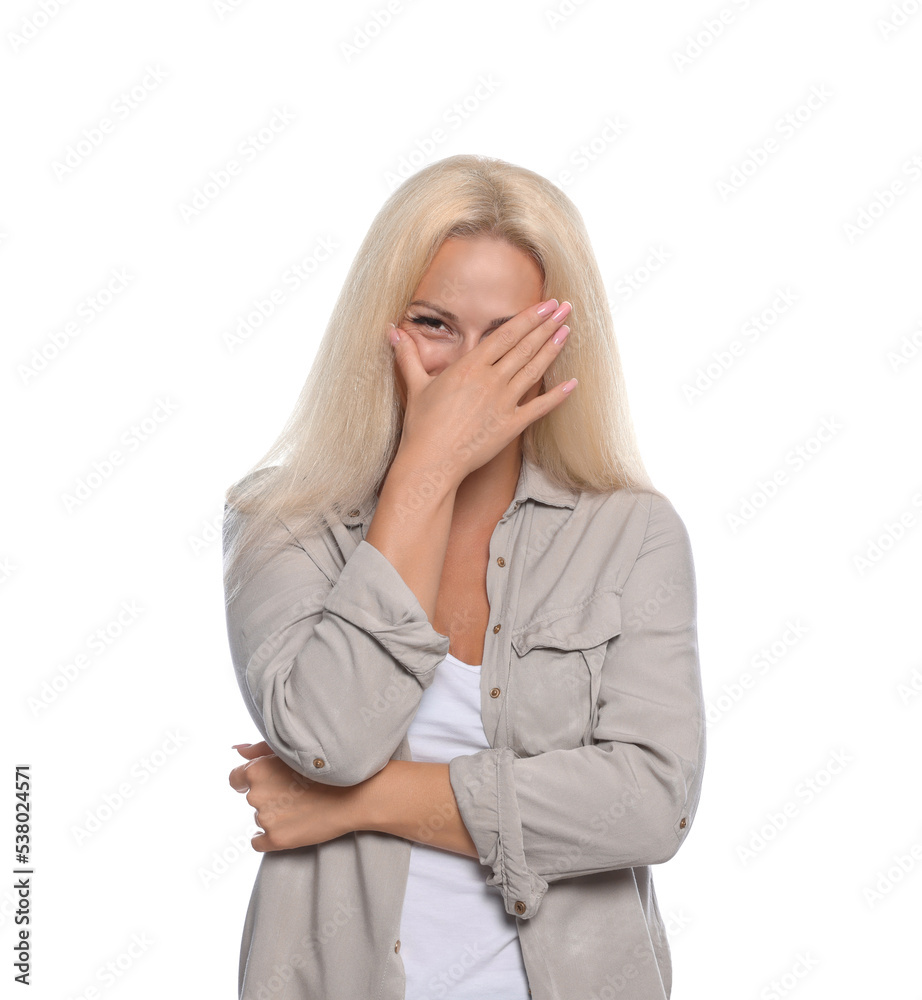 Embarrassed woman covering face with hand on white background Embarrassed woman covering face with hand on white background