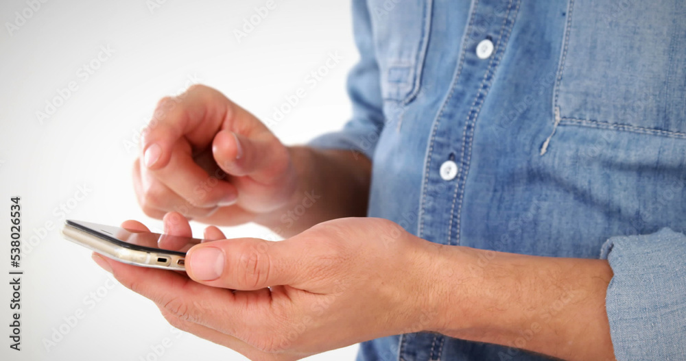 Midsection of caucasian man using cellphone against white background, copy space Midsection of caucasian man using cellphone against white background, copy space