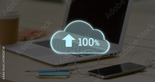 Composite of 1000 number with arrow and percentage sign in cloud over laptop, phone on desk