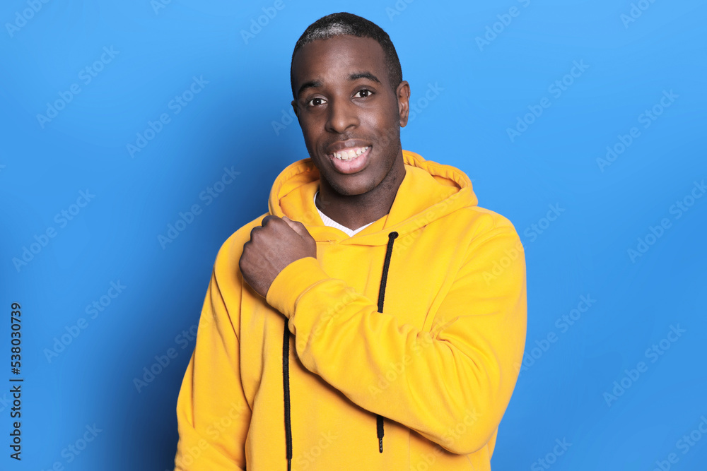 Portrait of happy afro american bearded man looking at camera on blue background Portrait of happy afro american bearded man looking at camera on blue background