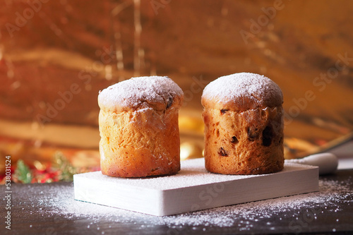 Traditional Italian panettones on a gold background photo