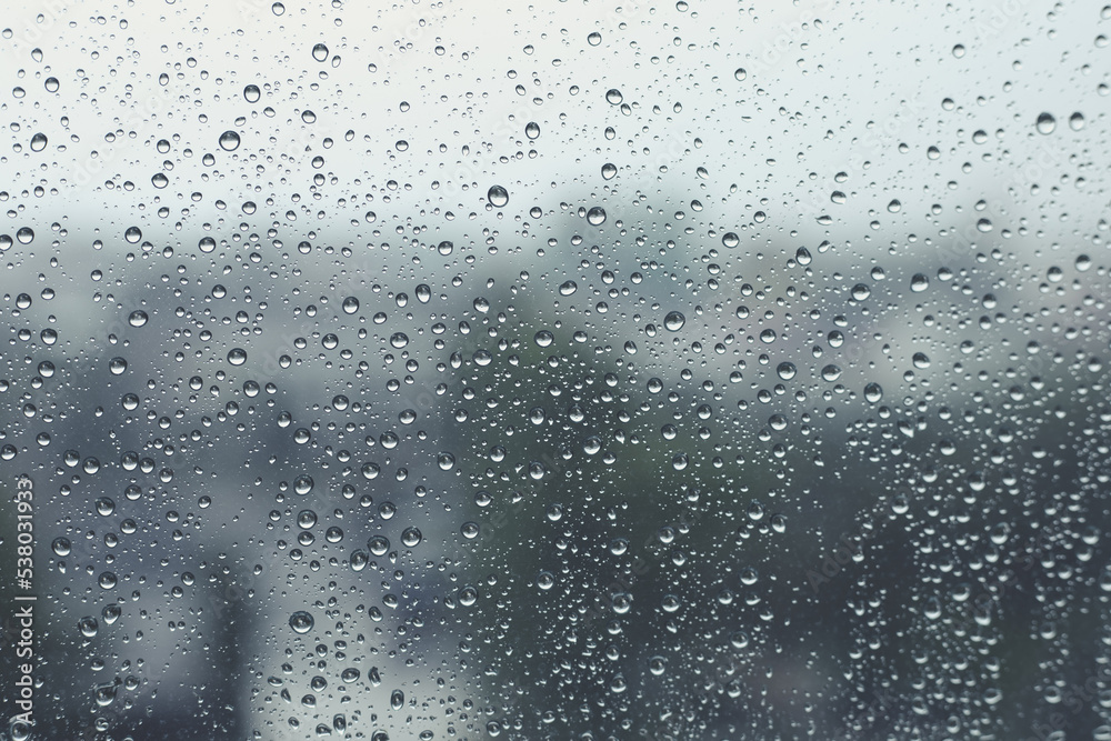 Rain drops on window with blurred  background,Rainy day,Water drop on glass,Feeling lonely concept.