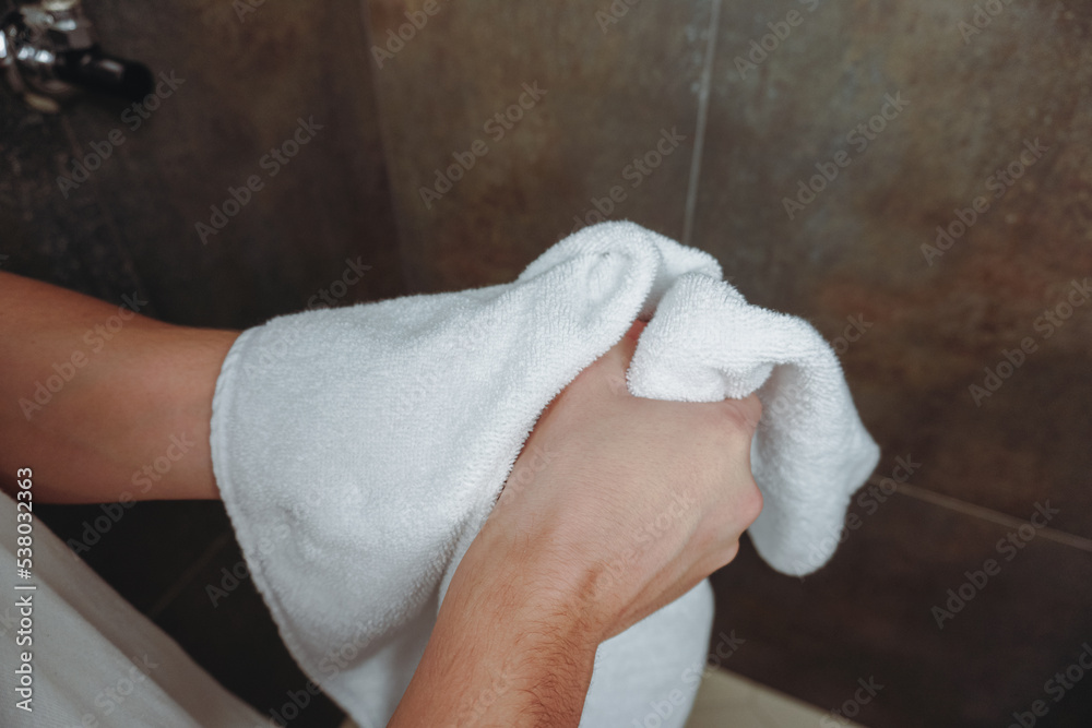 Wiping hands on a towel. The man is wiping his hands on a towel after