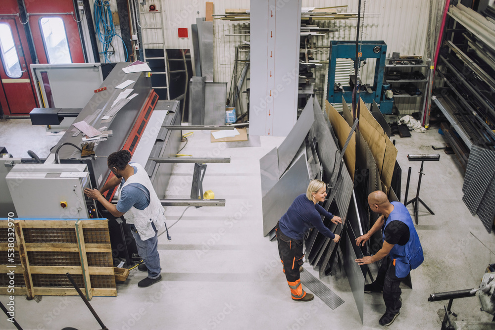 Full length of male and female carpenters working in workshop Full length of male and female carpenters working in workshop