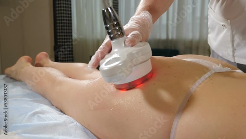 Female legs and hips at skin tightening procedure in beauty clinic. Body treatment: woman getting rf lifting program for her buttocks. Perfect shape buttocks on anti-cellulite treatment. 4 k video