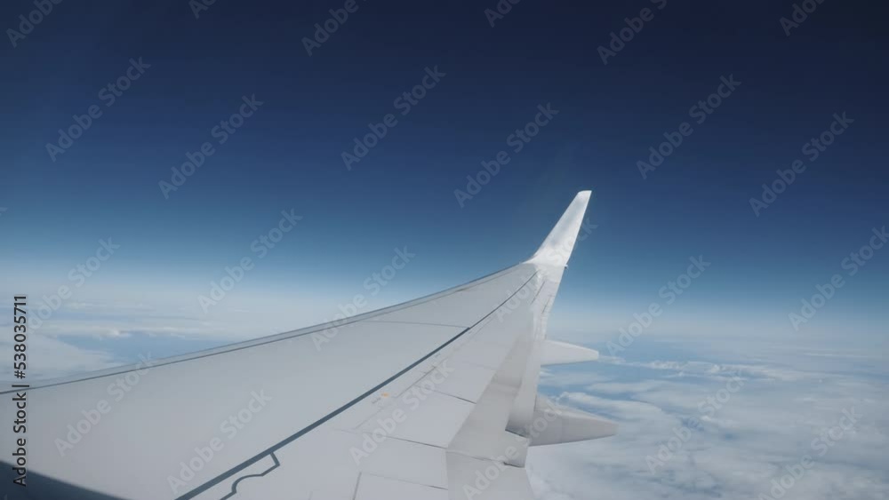 Plane wing flying fast over the clouds Plane wing flying fast over the clouds