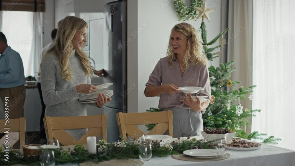 Caucasian big family preparing table for Christmas Eve. Shot with RED helium camera in 8K. Caucasian big family preparing table for Christmas Eve. Shot with RED helium camera in 8K.