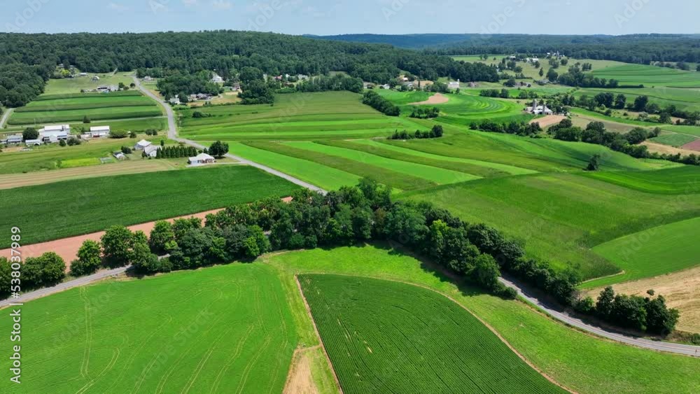 An aerial view over the lush green farmland in southern Lancaster County, Pennsylvania on a sunny summer day. An aerial view over the lush green farmland in southern Lancaster County, Pennsylvania on a sunny summer day.