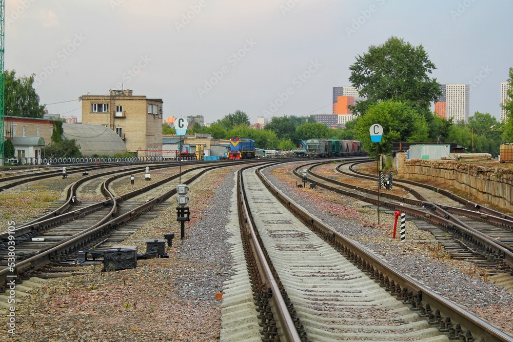 Naklejka premium Railway line junction tracks. Railroad travel, tourism.Transportation concept. Iron detail over dark stones. Heavy industrial landscape. Technology modern infrastructure development. Close up