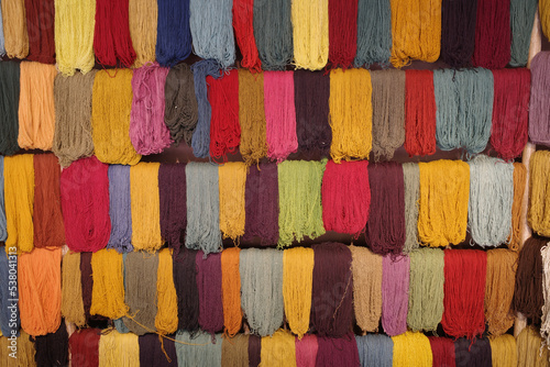 Cusco, Peru - 1 July, 2022: Andean textile weaving made with naturaly dyed Alpaca wool photo