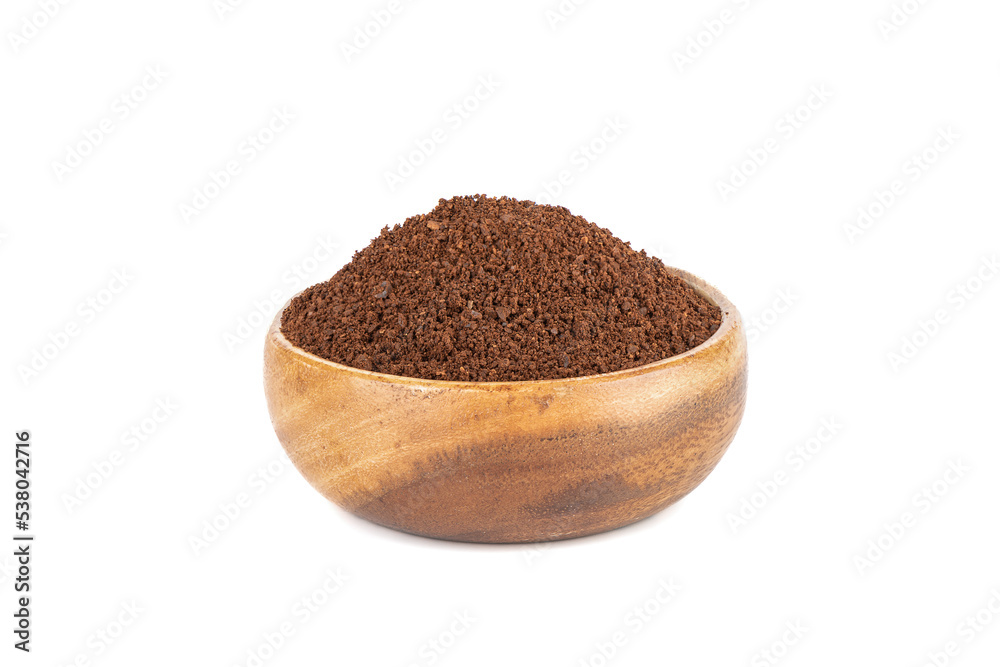 Ground coffee in a wooden bowl over a white background. Ground coffee in a wooden bowl over a white background.