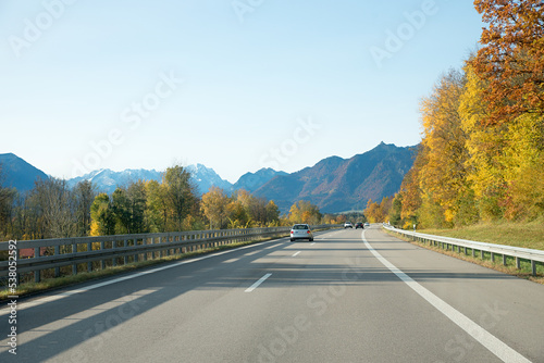 highway to Garmisch-Partenkirchen and bavarian alps in autumn, blue sky with copy space