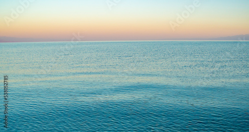 The surface of the water in the Issyk Kul mountain lake in Kyrgyzstan at sunset