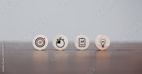 Target or goal with strategy plan, success business revenue concept. Symbols of arrows, diagrams businesses are present on wood cube. objective management, achievement startup, growth marketing idea.