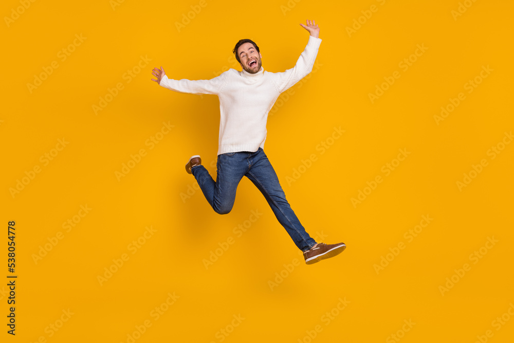 Photo of funky childish guy dressed white sweater running jumping high isolated yellow color background