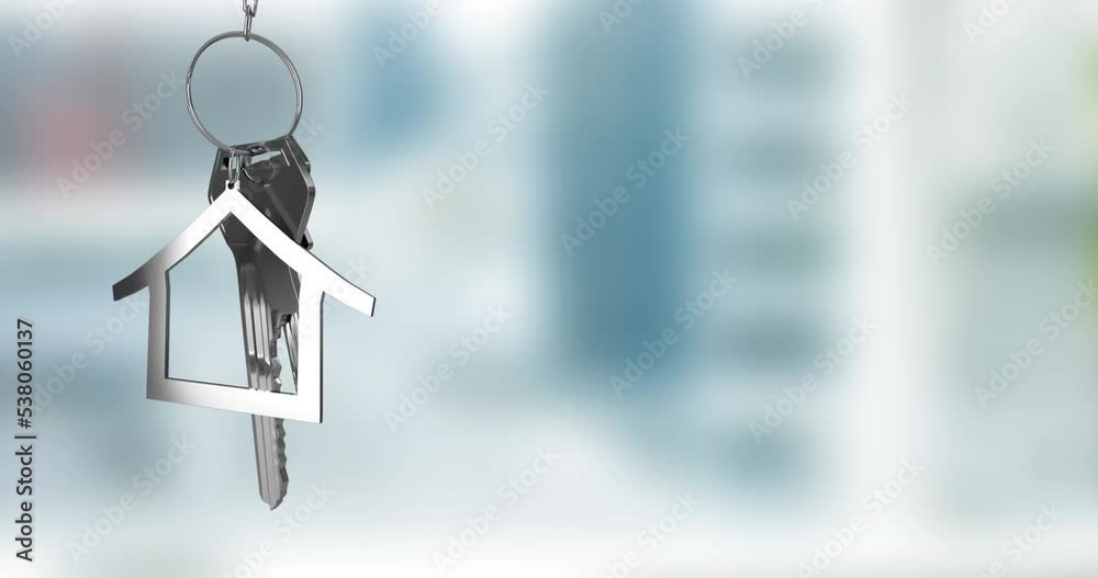 Animation of silver house key fob and key dangling over out of focus interiors with copy space