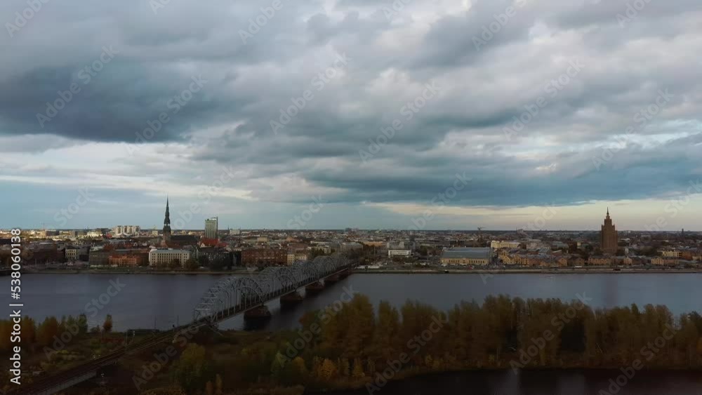 Aerial View of Riga City the Capital of Latvia. Amazing View on the River Daugava, Old Town, National Library, Bridges Over the River and the Main Tv Tower. View From Above During Autumn Cloudy Day 4K