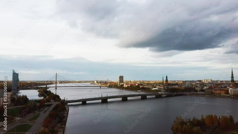 Aerial View of Riga City the Capital of Latvia. Amazing View on the River Daugava, Old Town, National Library, Bridges Over the River and the Main Tv Tower. View From Above During Autumn Cloudy Day 4K Aerial View of Riga City the Capital of Latvia. Amazing View on the River Daugava, Old Town, National Library, Bridges Over the River and the Main Tv Tower. View From Above During Autumn Cloudy Day 4K