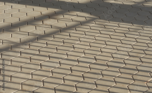 Abstract background and texture of hexagon cobblestone pavement with sunlight and shadow on surface