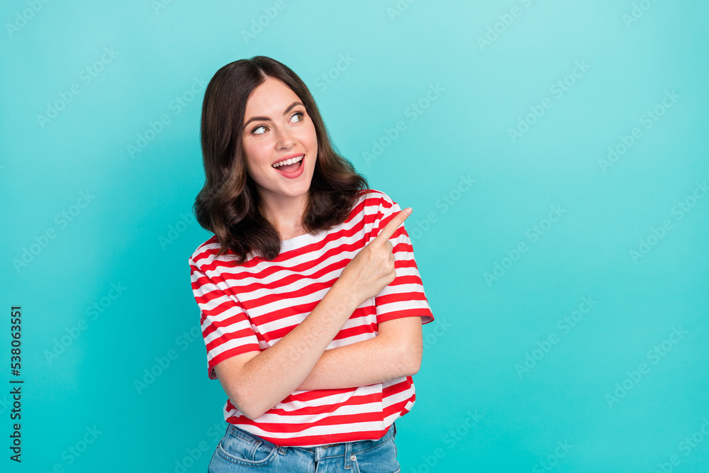 Photo of positive satisfied lady arm direct show empty space cool proposition stylish striped clothes isolated on cyan color background Photo of positive satisfied lady arm direct show empty space cool proposition stylish striped clothes isolated on cyan color background