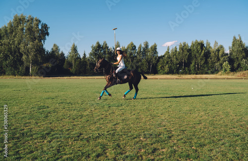 Female rider galloping on horse on meadow © BullRun