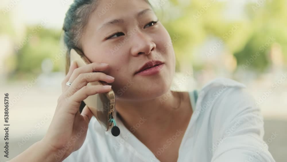 Close-up of young woman talking on cell phone