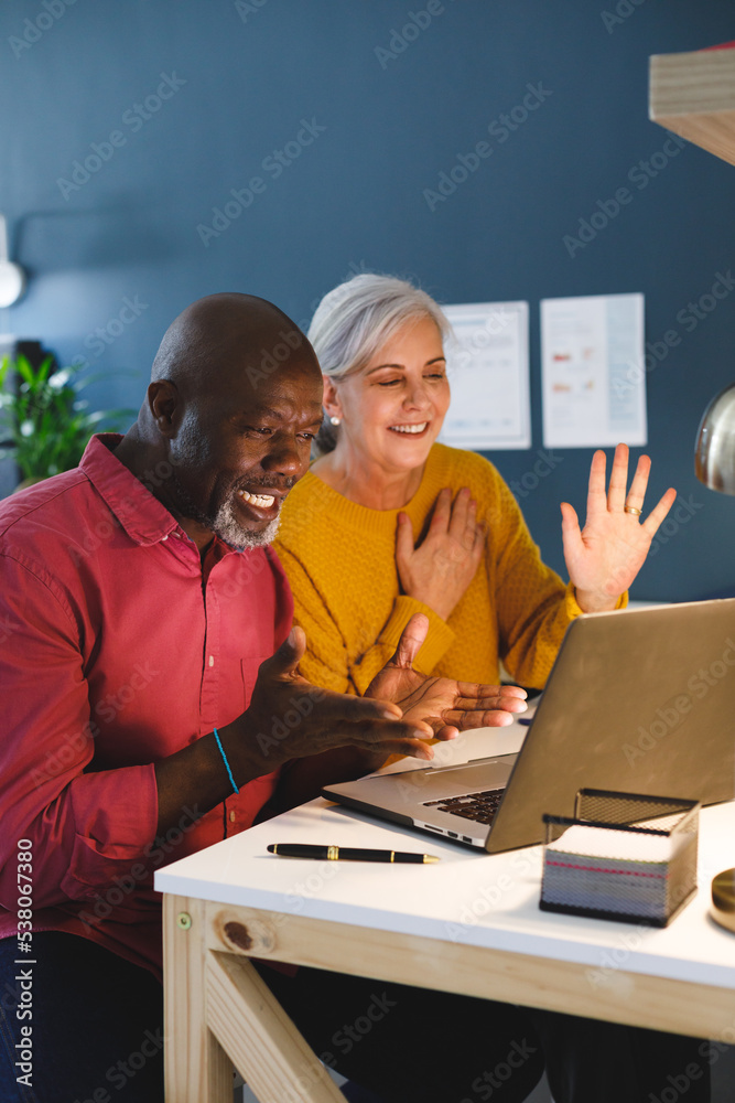 Senior diverse couple sitting at table and working Senior diverse couple sitting at table and working