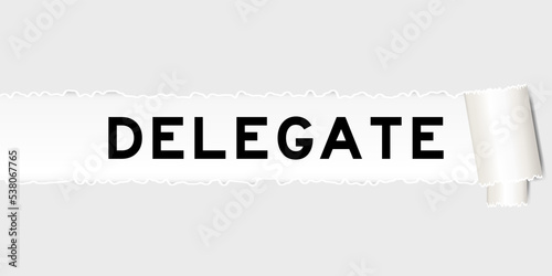 Ripped gray paper background that have word delegate under torn part